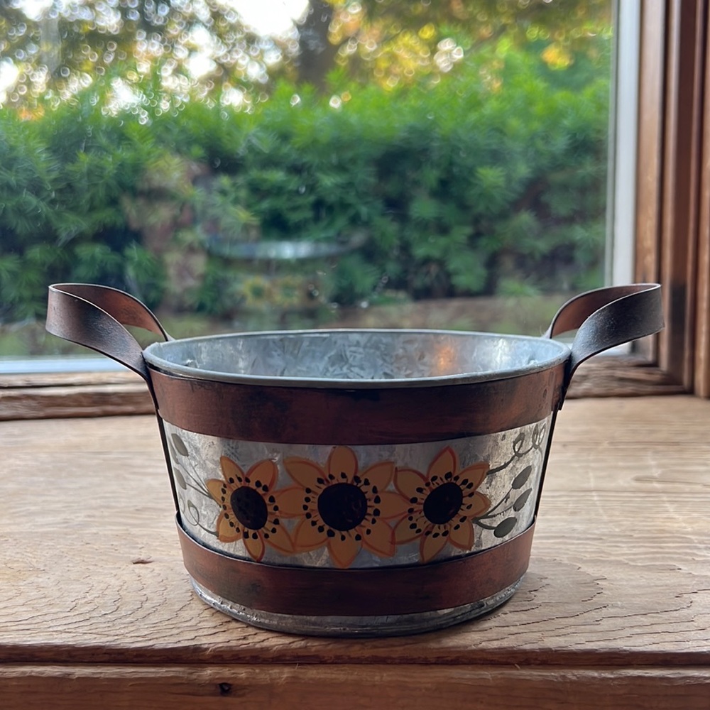 Metal sunflower container.